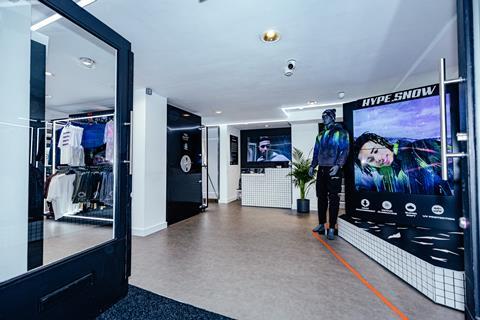 Interior of Hype Carnaby Street store showing a mannequin in a snowsuit and the a sign reading 'Hype.Snow'. There is vault to the left of the image